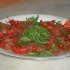 Filetti di trota salmonata affumicata in carpaccio con rucola ed erba cipollina