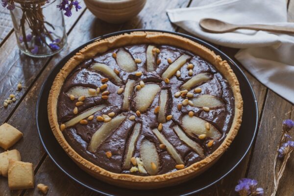 Non è la solita torta cioccolato e pere: qui ci sono anche le mandorle, intere e in polvere nella frolla