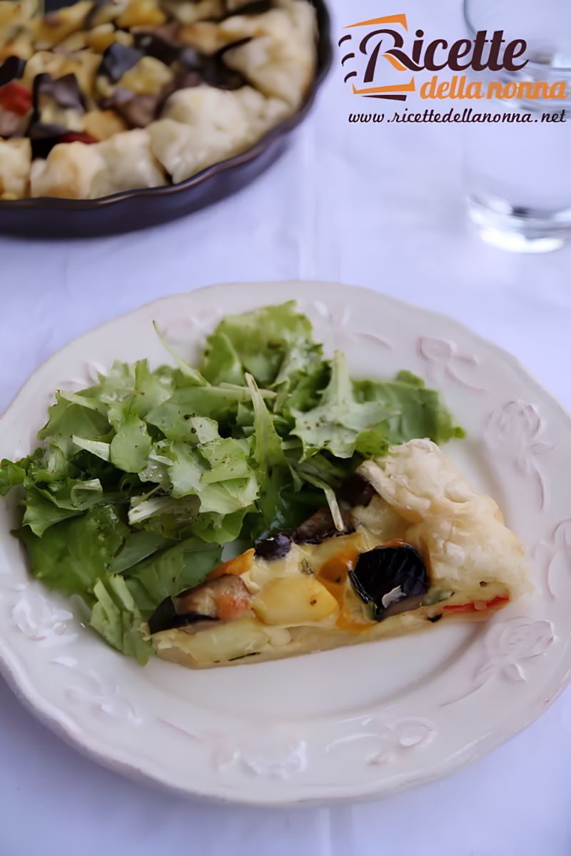 Torta salata alle verdure di stagione su un piatto bianco. Primo piano